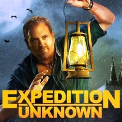 Expedition Unknown star Josh Gates holding a lantern