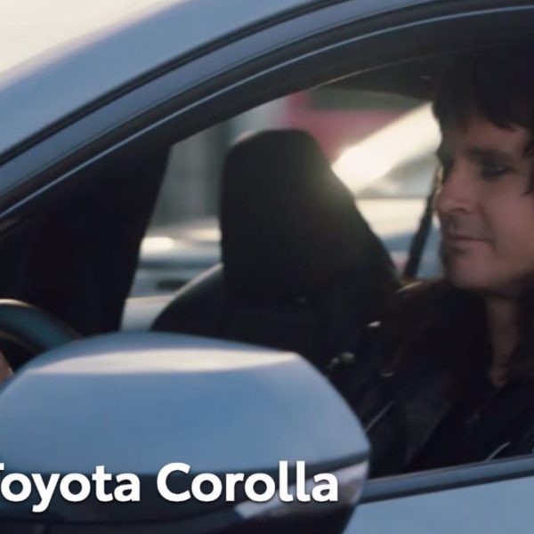 Toyota Corolla with a male driver in metal makeup