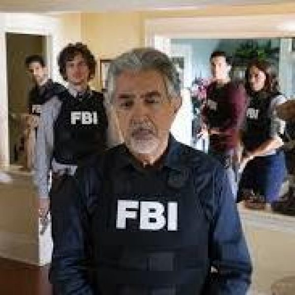 Criminal Minds cast in FBI vests with a gray haired Joe Mantegna in the forefront