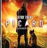 Star Trek Picard CBS All Access. Jean Luc looks down at a dog, in front of a vineyard, lit by a vast sunset
