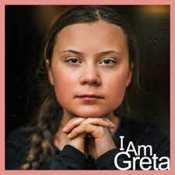 Greta with her hands folded together over the title