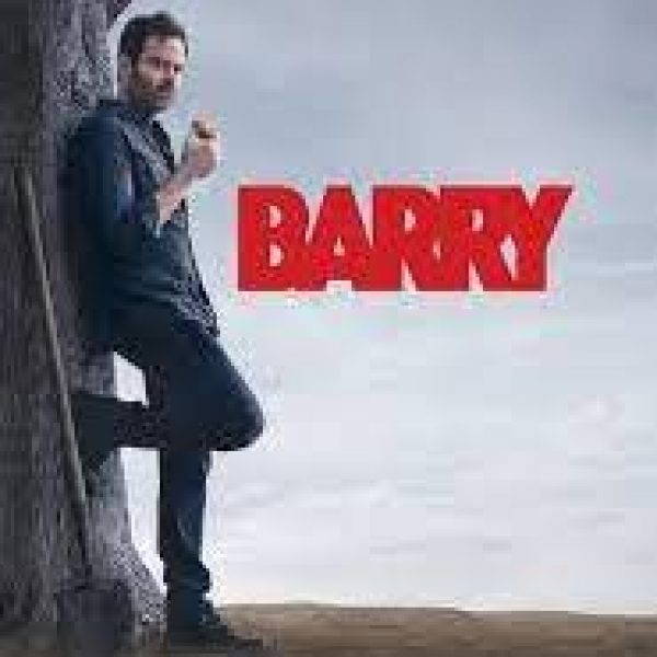 Barry leaning against a tree with a shovel beside him