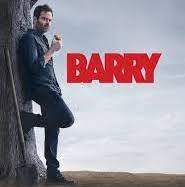 Barry leaning against a tree with a shovel beside him