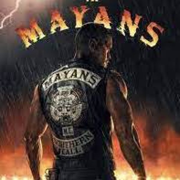Muscular man in side profile with a jacket that say Mayans on the back